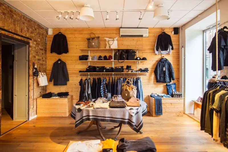 Retail-Cleaning Rustic clothing store features light wood paneling